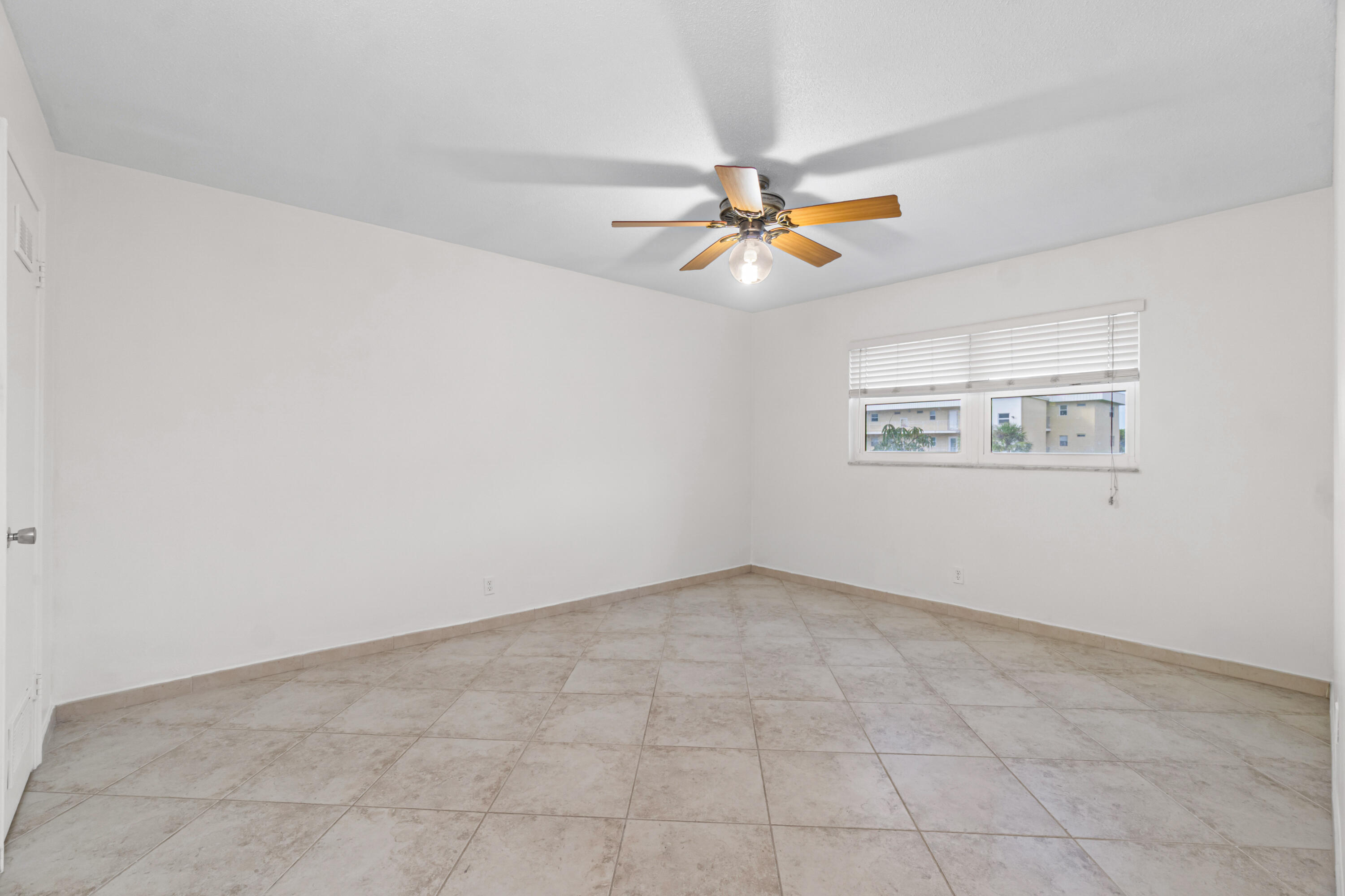 2615 Northeast 1st Court, Unit 303 Boynton Beach, FL 33435 - Photo 31 of 44 an empty room with windows and fan