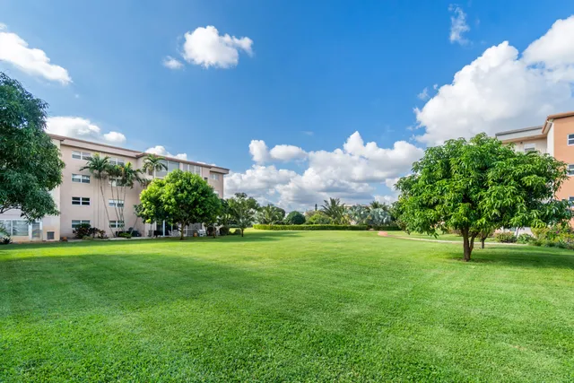 a front view of a house with a big yard