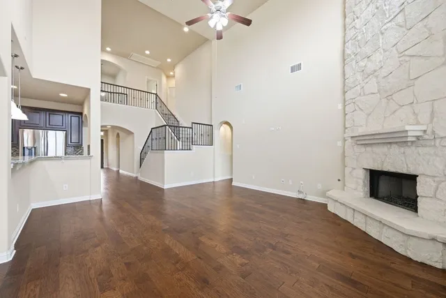 a view of a livingroom with wooden floor and a fireplace