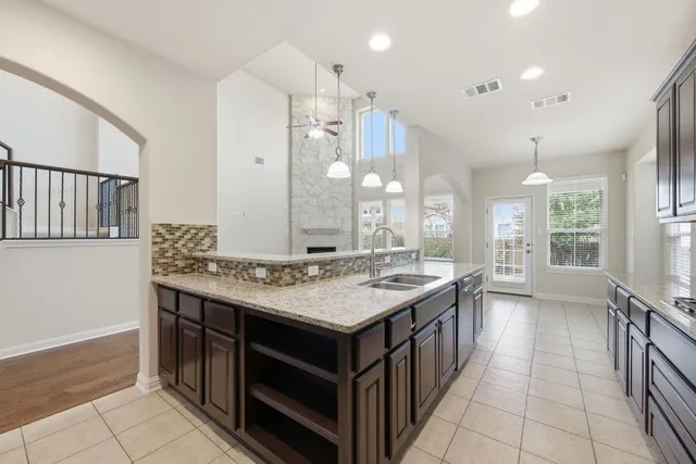 a bathroom with a granite countertop sink a large mirror and a shower