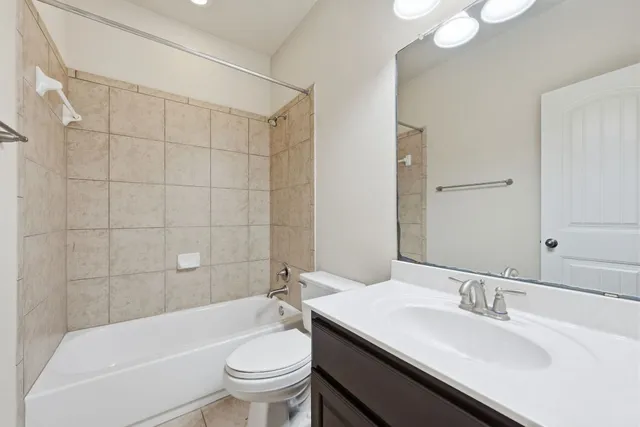 a bathroom with a sink a toilet and bathtub