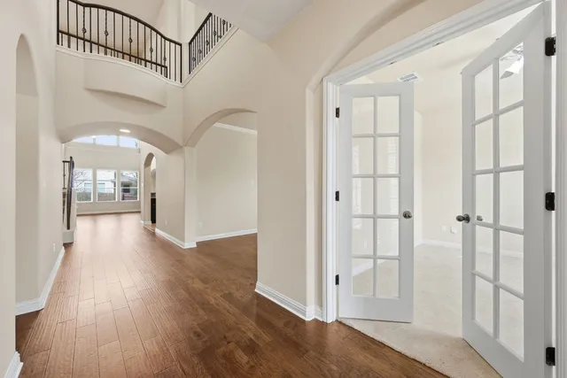 a view of a hallway view with wooden floor and staircase