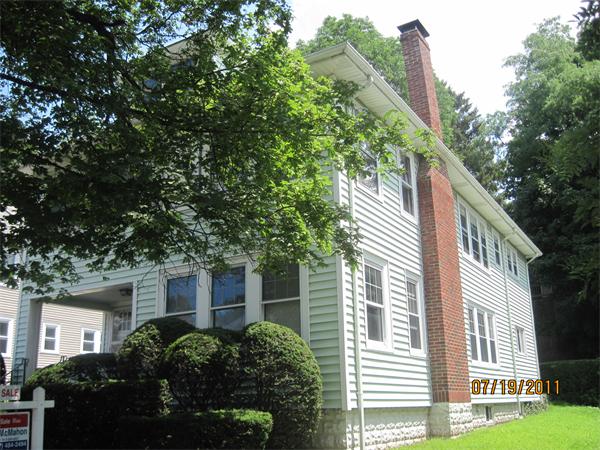 23-25 Channing Road Watertown, MA 02472 - Photo 3 of 12 a front view of a house with a garden