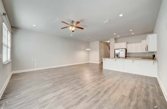 a view of kitchen with wooden floor and electronic appliances