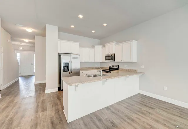 a view of kitchen with sink microwave and refrigerator