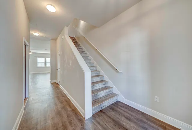 a view of entryway and hall with wooden floor
