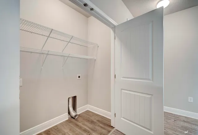 a room with walk in closet and wooden floor