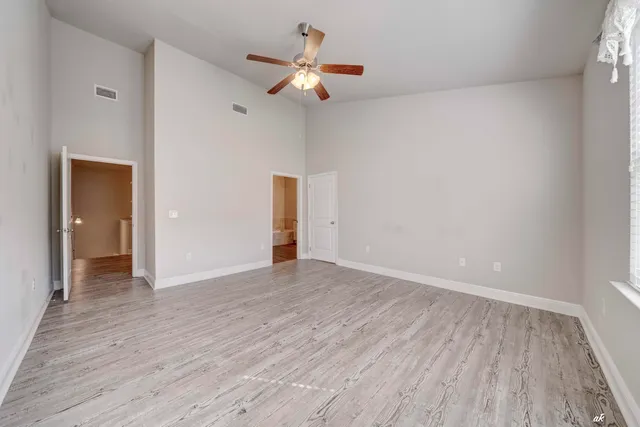 wooden floor in an empty room with a window