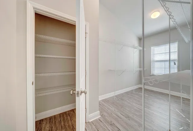 a spacious bathroom with a granite countertop sink mirror and toilet