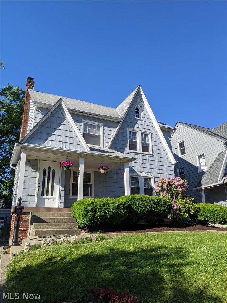 3511 Northcliffe Road Cleveland, OH 44118 - Photo 2 of 46 Gabled roofline with dormer windows, shingle siding, covered front porch, concrete entry steps, and established landscaping
