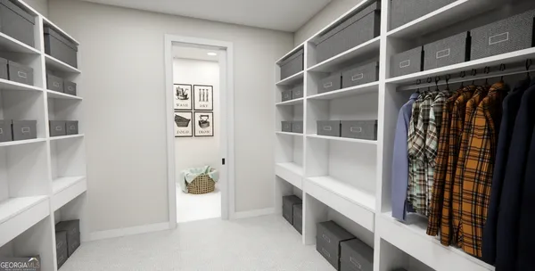 a view of walk in closet with clothes and shoes
