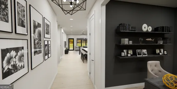 a hallway with painting on the wall and a potted plant