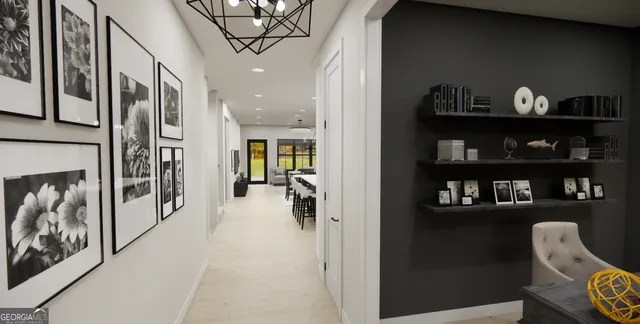 a hallway with painting on the wall and a potted plant