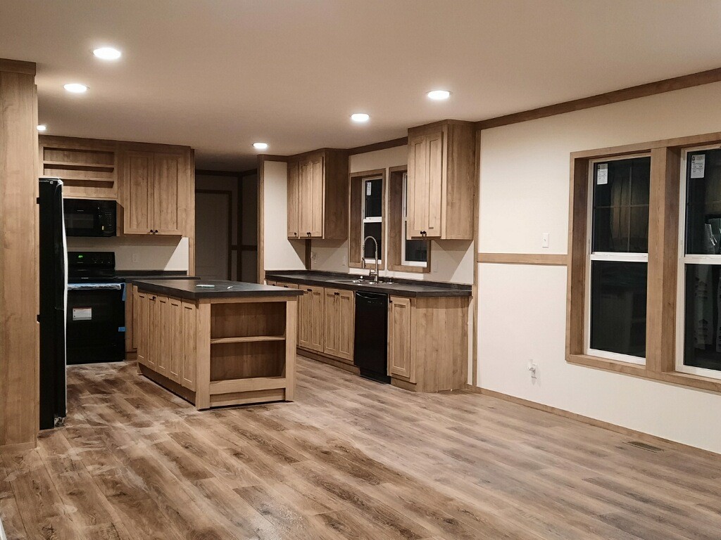 351 Calvert Ridge Road Westmoreland, TN 37186 - Photo 7 of 31 a kitchen with stainless steel appliances kitchen island granite countertop a refrigerator and a sink