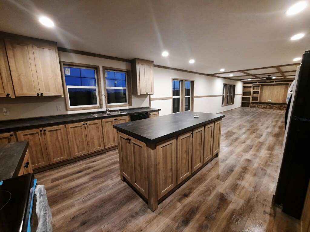 351 Calvert Ridge Road Westmoreland, TN 37186 - Photo 8 of 31 a kitchen with kitchen island granite countertop a sink a counter top space and stainless steel appliances