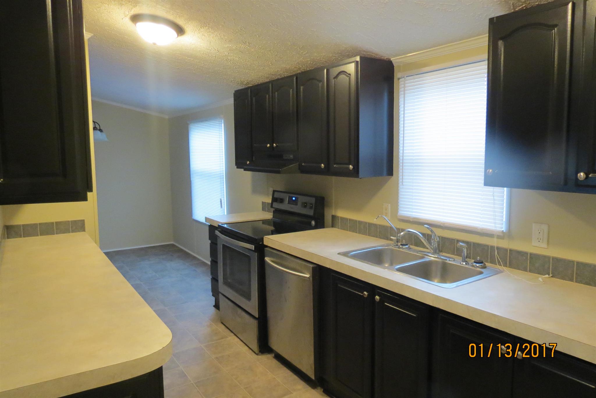 898 Bell Road Watertown, TN 37184 - Photo 5 of 23 a kitchen with a sink a stove and a refrigerator