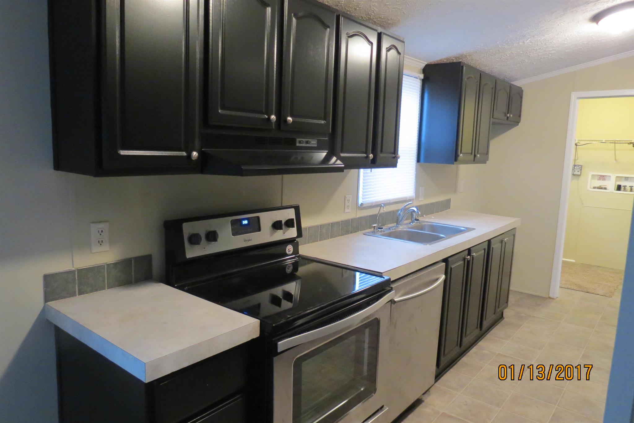 898 Bell Road Watertown, TN 37184 - Photo 8 of 23 a kitchen with a stove sink and cabinets