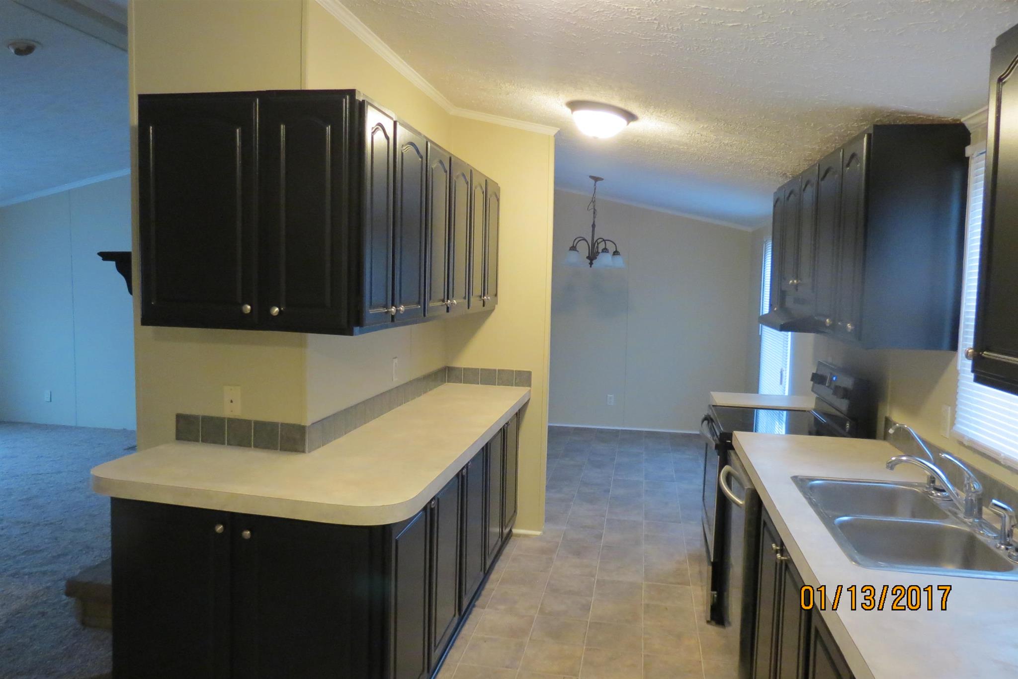 898 Bell Road Watertown, TN 37184 - Photo 9 of 23 a kitchen with a sink and a refrigerator