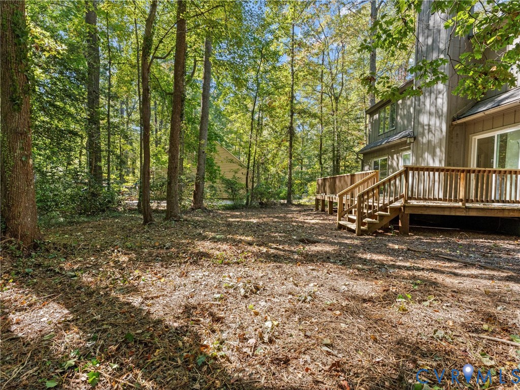 3601 Quail Meadows Place Midlothian, VA 23112 - Photo 21 of 27 View of yard with a deck, a forest view, and stair