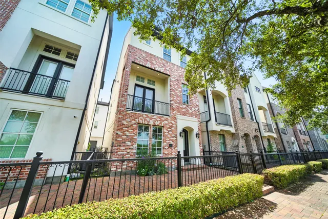 a view of a brick house many windows