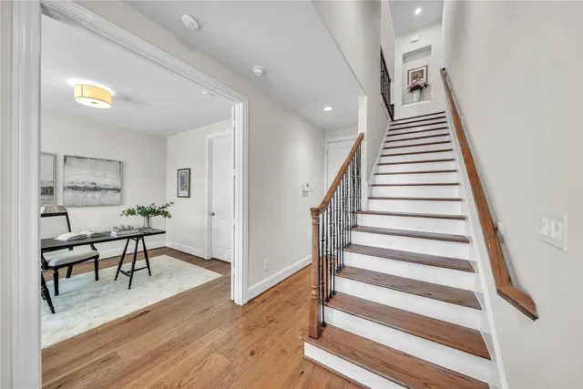 a view of entryway and hall with wooden floor