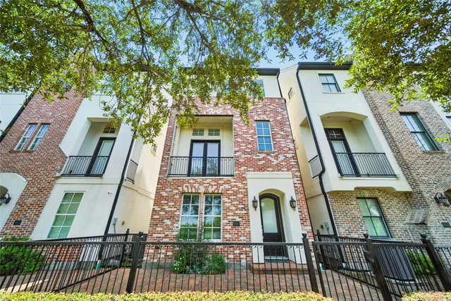 front view of a house with a tree