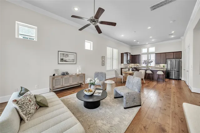 a living room with lots of furniture and view of kitchen