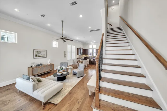 a living room with furniture and wooden floor