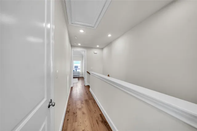 a view of a hallway with wooden floor