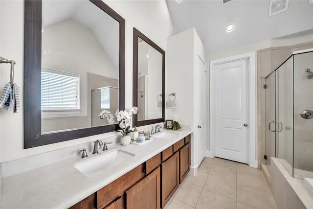 a bathroom with a double vanity sink mirror and double