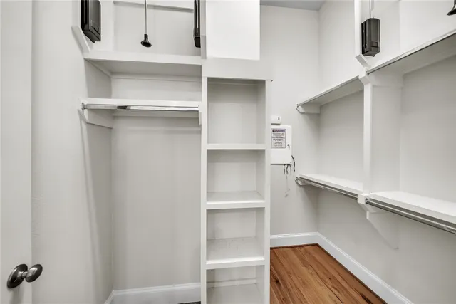 a view of walk in closet with empty racks