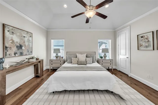 a bedroom with a large bed and a chandelier