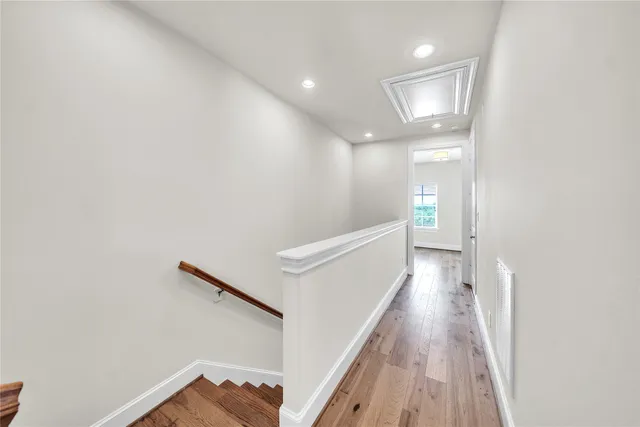 a view of a hallway with wooden floor