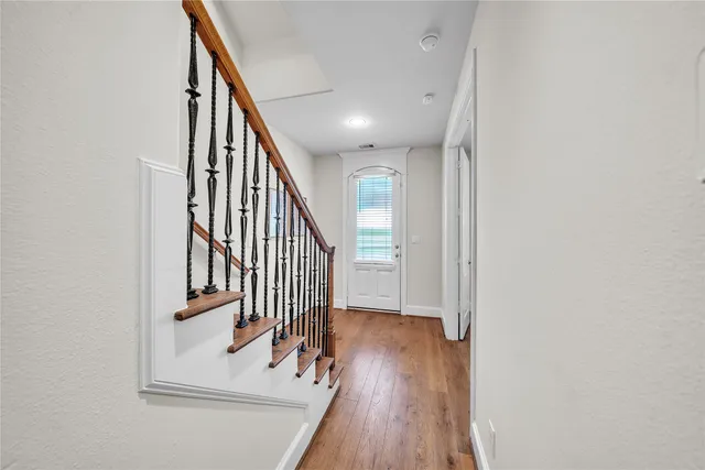 a view of entryway and hall with wooden floor