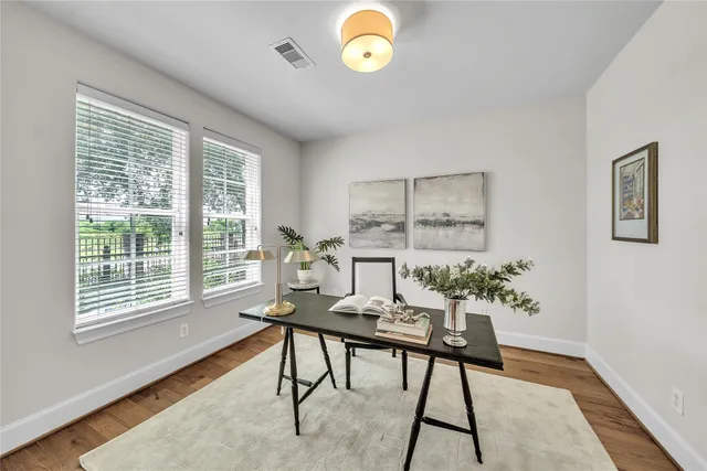 a workspace room with furniture and a window