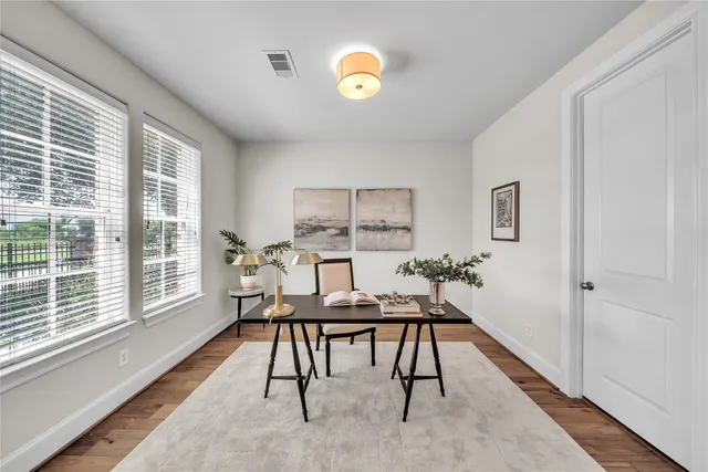 a view of a workspace with furniture and a window