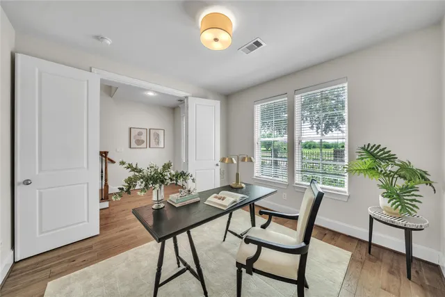 a view of a dining room with furniture window and wooden floor