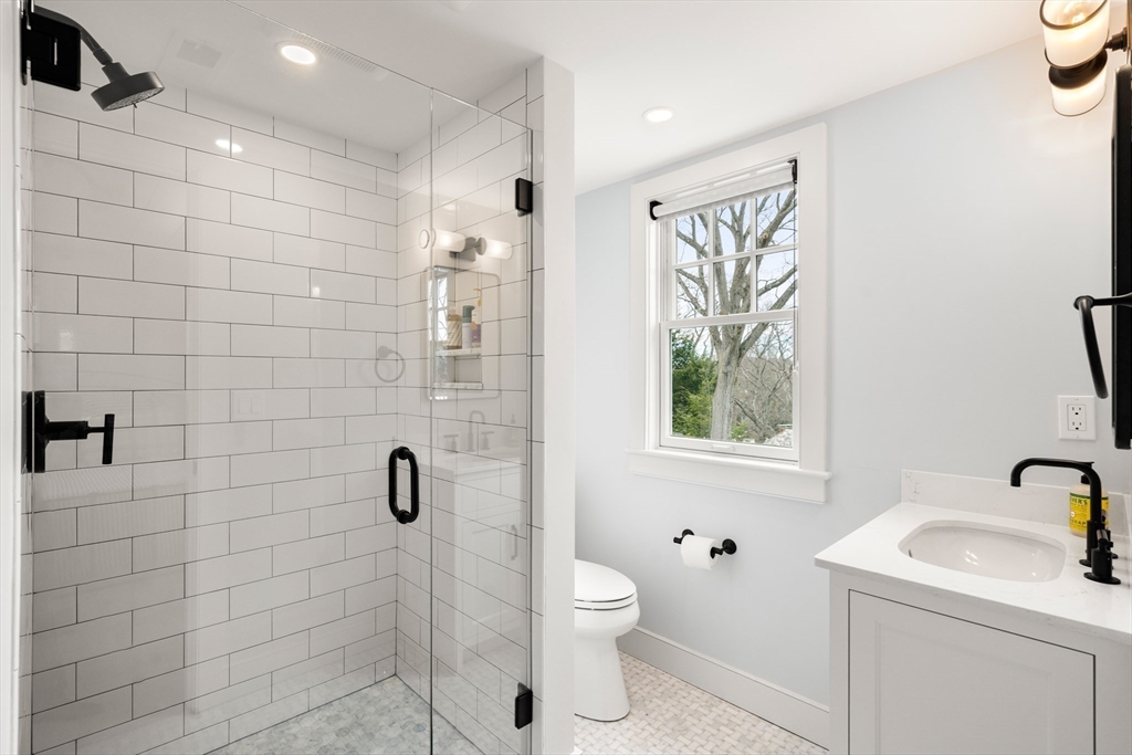 3 Cleveland Road Brookline, MA 02445 - Photo 13 of 27 a bathroom with a toilet sink a window and shower