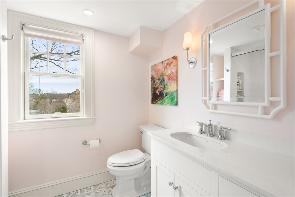 3 Cleveland Road Brookline, MA 02445 - Photo 16 of 27 a bathroom with a toilet a sink a mirror and a window
