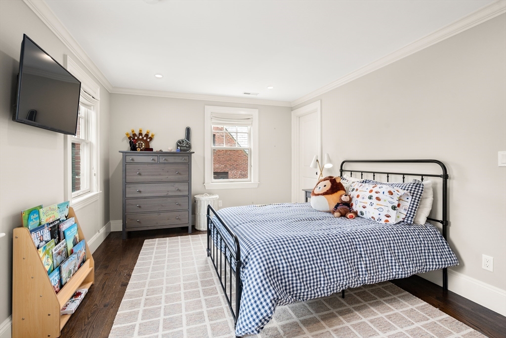 3 Cleveland Road Brookline, MA 02445 - Photo 19 of 27 a bedroom with a bed and flat screen tv