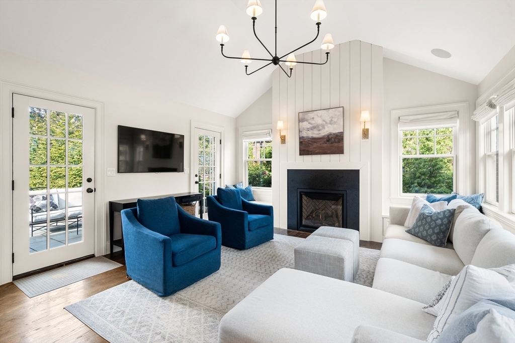 3 Cleveland Road Brookline, MA 02445 - Photo 2 of 27 a living room with furniture a flat screen tv and a fireplace