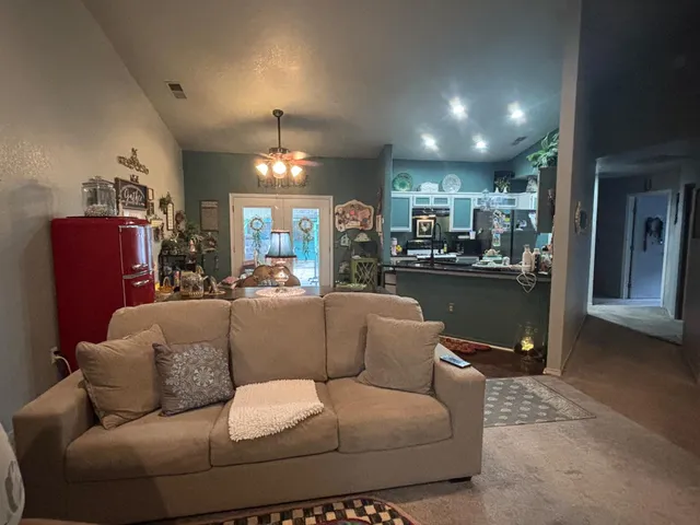 a living room with furniture and a chandelier