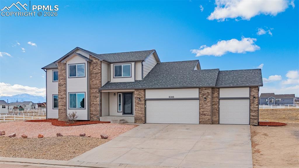 8388 Fort Smith Road Peyton, CO 80831 - Photo 1 of 49 a front view of a house with garden