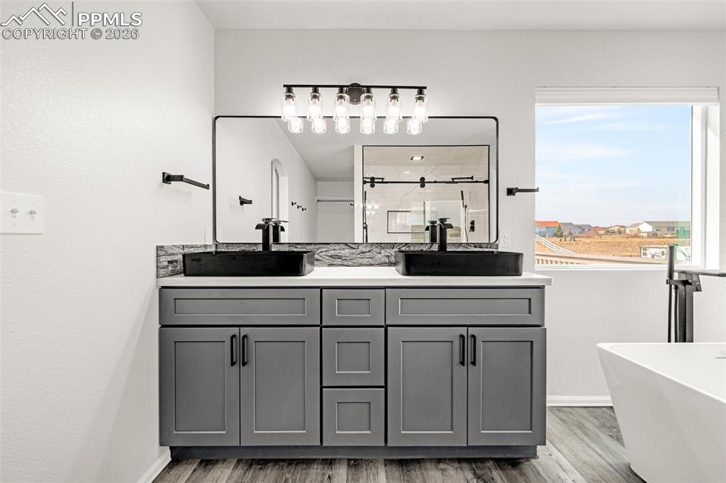 8388 Fort Smith Road Peyton, CO 80831 - Photo 13 of 49 a sink with a large mirror