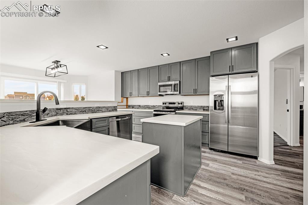 8388 Fort Smith Road Peyton, CO 80831 - Photo 15 of 49 a kitchen with a sink a refrigerator and cabinets