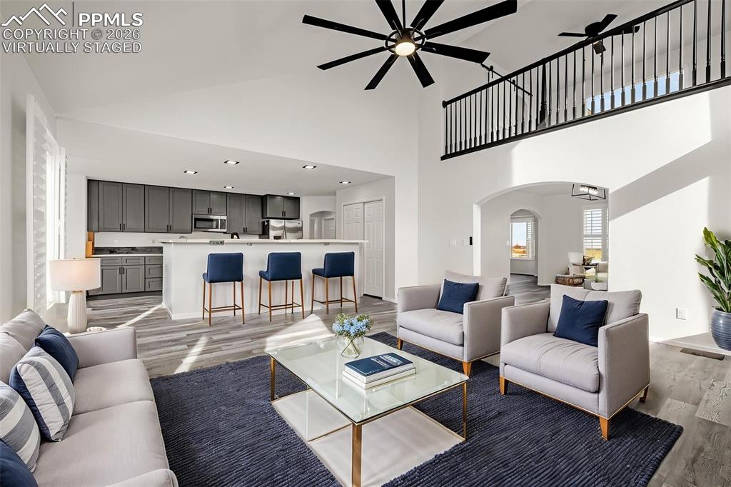 8388 Fort Smith Road Peyton, CO 80831 - Photo 18 of 49 a living room with furniture kitchen view and a wooden floor