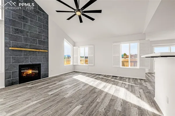 a view of a livingroom with a fireplace and window