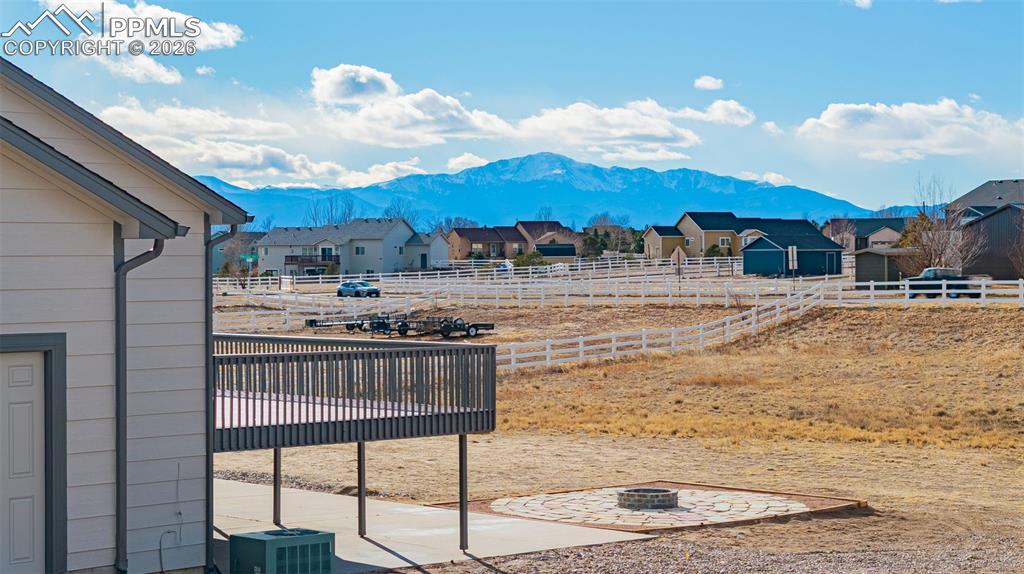 8388 Fort Smith Road Peyton, CO 80831 - Photo 2 of 49 a kitchen with kitchen island granite countertop a table chairs and a stove