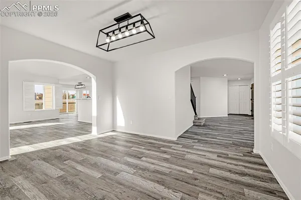 a view of a hallway with wooden floor and staircase