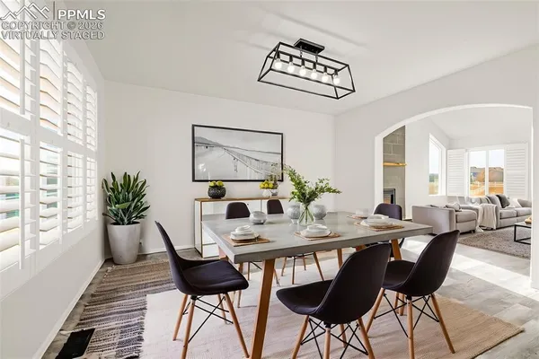 a view of a dining room with furniture and wooden floor